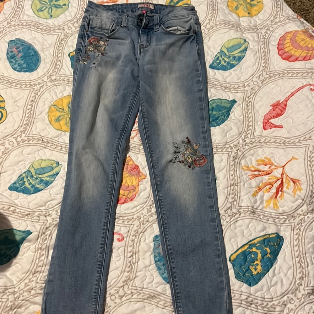 YMI light wash skinny jeans.  Destroyed with flowers.  Size 10.